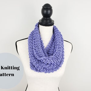 May include: A purple knitted infinity scarf on a white mannequin. The scarf is made with a simple stitch pattern and has a soft, drapey texture. PDF Knitting Pattern.