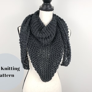 May include: A black knitted triangular scarf displayed on a white mannequin. The scarf is made with a simple stitch pattern and has a loose, drapey feel. PDF Knitting Pattern.