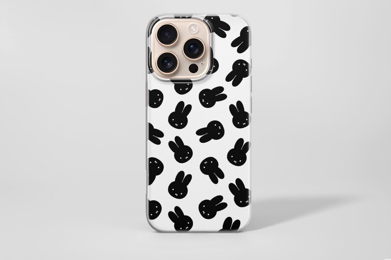 Puede incluir: Funda transparente para tel&eacute;fono con fondo blanco y un patr&oacute;n repetido de caras de conejos negros. La funda tiene un recorte para la c&aacute;mara y est&aacute; dise&ntilde;ada para un tel&eacute;fono inteligente.