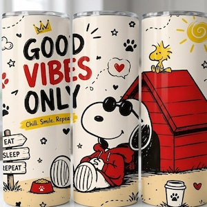 May include: A cylindrical tumbler with a cream background featuring Snoopy wearing sunglasses and a red hoodie in front of a red doghouse. The text reads GOOD VIBES ONLY, Chill. Smile. Repeat., and EAT SLEEP REPEAT on a sign. Includes Woodstock, a sun, and paw prints.