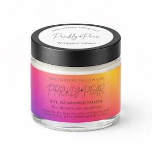 May include: A glass jar with a black lid, labeled "Prickly Pear Whipped Tallow." The jar has a colorful gradient label with text that reads "2 Fl. Oz." and lists ingredients. The product is for skincare.