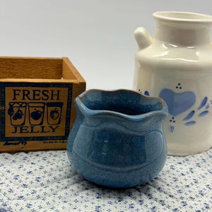 May include: A set of three ceramic mugs with a speckled, matte finish. The mugs are in shades of cream, light gray, and dark gray. Each mug has a simple, minimalist design, perfect for coffee or tea.