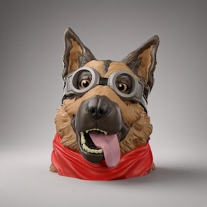 May include: A sculpted bust of a German Shepherd dog wearing gray aviator-style goggles over its eyes and a bright red bandana around its neck. The dog has brown and tan fur, a black nose, and an open mouth with a pink tongue hanging out.