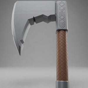 May include: A grey axe with a wide, flat blade featuring a notched underside. The head includes a rectangular section with engraved geometric patterns. The handle is cylindrical with a brown, diamond-textured grip and a solid grey base cap.