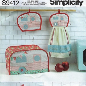 May include: A collection of kitchen accessories with a camper theme. Includes a toaster cover, pot holders, a towel, and a utensil holder. The items feature a red, blue, and white color scheme with a retro camper design. The pattern is from Simplicity.