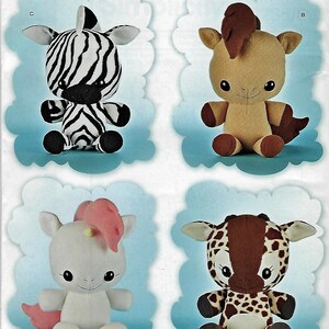 May include: A sewing pattern envelope titled Teacup Lion Designs H0236 featuring four plush animal toys: a black and white zebra, a tan horse with a brown mane, a white unicorn with a pink mane and tail, and a brown and white spotted giraffe.