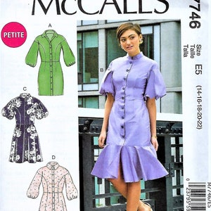 May include: McCall's M7746 sewing pattern featuring a woman's dress with a button-down front and a flared hem. The pattern includes multiple dress variations, with options for different sleeve styles and lengths. The size range is E5 (14-16-18-20-22).
