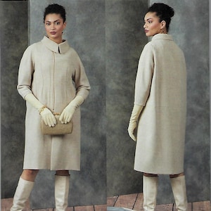 May include: Vogue Patterns sewing pattern V1911. The image shows a woman wearing a beige knee-length coat with a collar and long sleeves, paired with matching gloves and boots. The pattern is for sizes LRG-XLG-XXL.