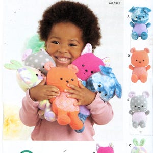 May include: Simplicity sewing pattern S9909 for stuffed animals in one size. The package features illustrations of various plush toys including a blue tie-dye bear, a solid orange bear, a pink cat, and a gray polka-dot rabbit with pastel accents.