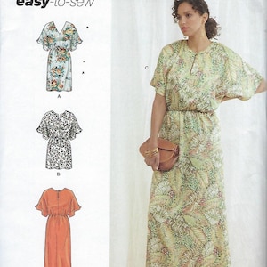 May include: Simplicity sewing pattern R11805 for sizes 18-26. The envelope displays three dress variations: a floral print, a leopard print, and a solid orange dress. A model wears a long, light green dress with a tropical leaf pattern and a slit neckline.