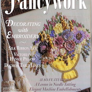 May include: The cover of "Fancywork" magazine features a colorful floral embroidery design in a yellow vase. Text includes "Decorating with Embroidery," "Silk Ribbon Art," and "Victorian Hankie Pillow." The magazine also features needle tatting and machine embellishments.