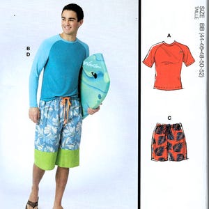 May include: McCall's M8517 sewing pattern envelope featuring illustrations and photos of a raglan sleeve shirt and board shorts. The shirt has blue sleeves and a teal body. The shorts feature a blue leaf print with a solid lime green hem.