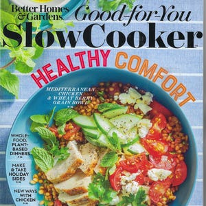 May include: A magazine cover featuring a vibrant Mediterranean chicken and wheat berry grain bowl. The bowl is filled with colorful ingredients like tomatoes, cucumbers, and herbs. The cover also includes text that reads "Good-for-You Slow Cooker" and "Healthy Comfort."