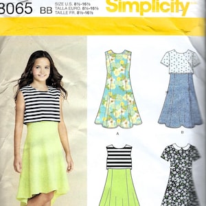 May include: Simplicity sewing pattern 3065 for sizes 8 1/2-16 1/2. The envelope features illustrations of sleeveless and short-sleeved dresses with various floral, striped, and solid patterns, including a high-low hemline and a Peter Pan collar.