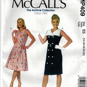 May include: A McCall's sewing pattern envelope for The Archive Collection Circa 1963, MP409. The front displays two dress variations: a sleeveless pink floral dress with a belt and a sleeveless navy blue dress with a white collar and white buttons.