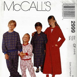 May include: A McCall's 2999 sewing pattern envelope featuring illustrations of children wearing a blue plaid sweatshirt and pants set, a white and red patterned pajama set, a blue plaid robe, and a solid red robe. The text includes Lanz of Salzburg.