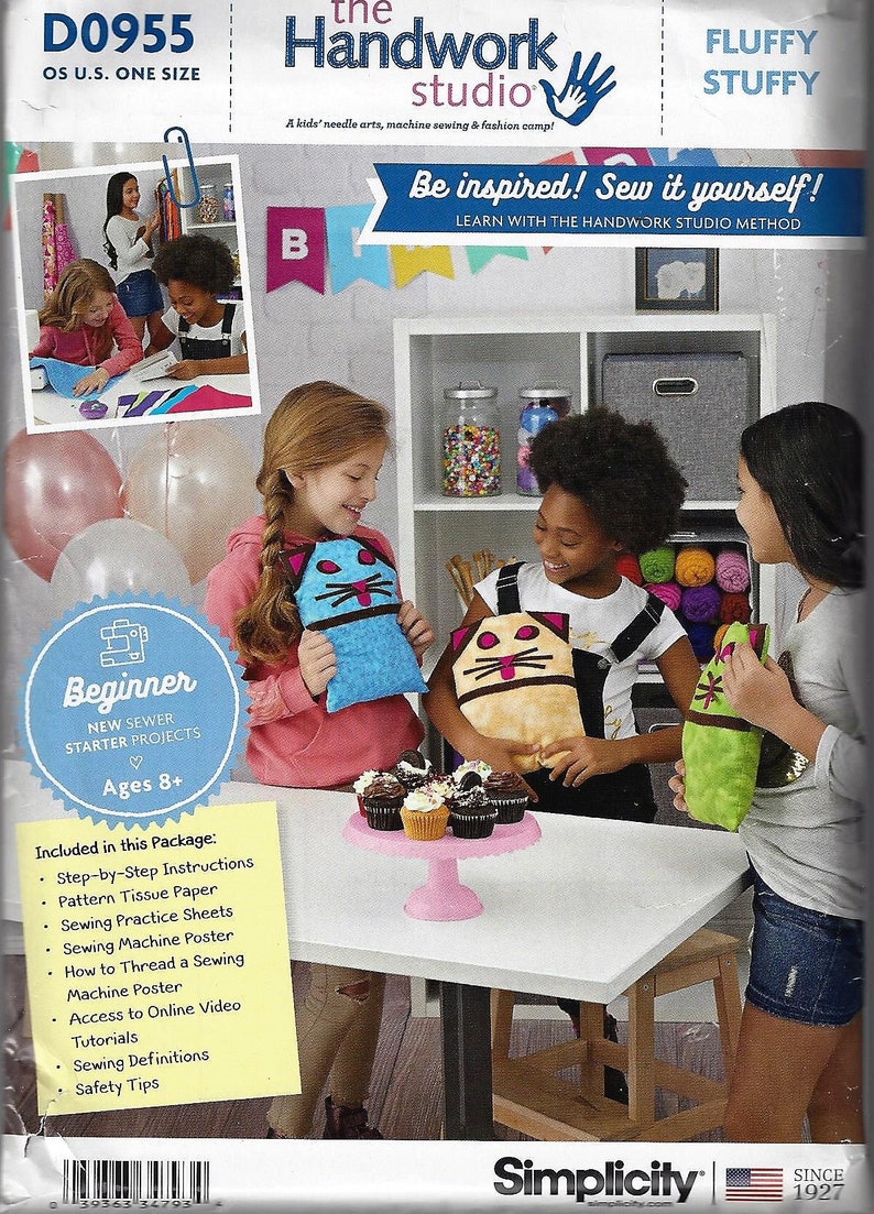 May include: A Simplicity sewing pattern package titled The Handwork Studio Fluffy Stuffy for beginner sewer starter projects. The packaging features text, a photo of children with plush toys, and a list of included items like instructions and patterns.