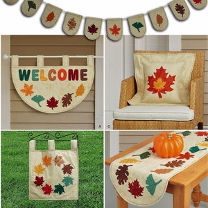 May include: A collection of fabric home decor items featuring autumn leaf motifs in shades of red, orange, brown, and green. The set includes a bunting banner, a semi-circular welcome wall hanging, a square pillow, a garden flag, and a table runner.