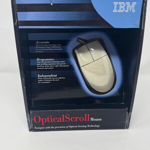 May include: An IBM Optical Scroll Mouse in its original blue and black packaging. The box features the text Accurate, Responsive, and Independent, highlighting optical sensing technology and step-n-scroll wheel technology for precise navigation.