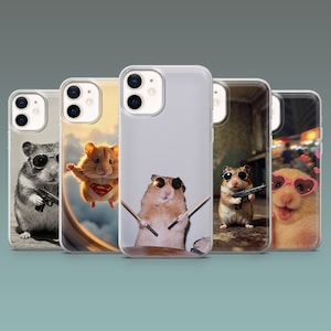 May include: A collection of phone cases featuring humorous images of hamsters. Each case displays a different hamster wearing sunglasses and engaging in various activities, including holding a gun, playing drums, and wearing a Superman costume.