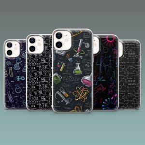 May include: A collection of phone cases with science-themed designs. The cases feature illustrations of laboratory equipment, chemical formulas, and periodic table elements. The color palette includes black, white, and vibrant accents of red, green, and yellow.
