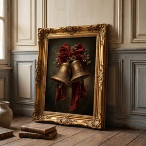 May include: A framed oil painting featuring two metallic gold bells tied together with a large, deep red velvet bow. The bells are adorned with small green holly leaves and red berries, set against a dark, moody background within an ornate gold frame.