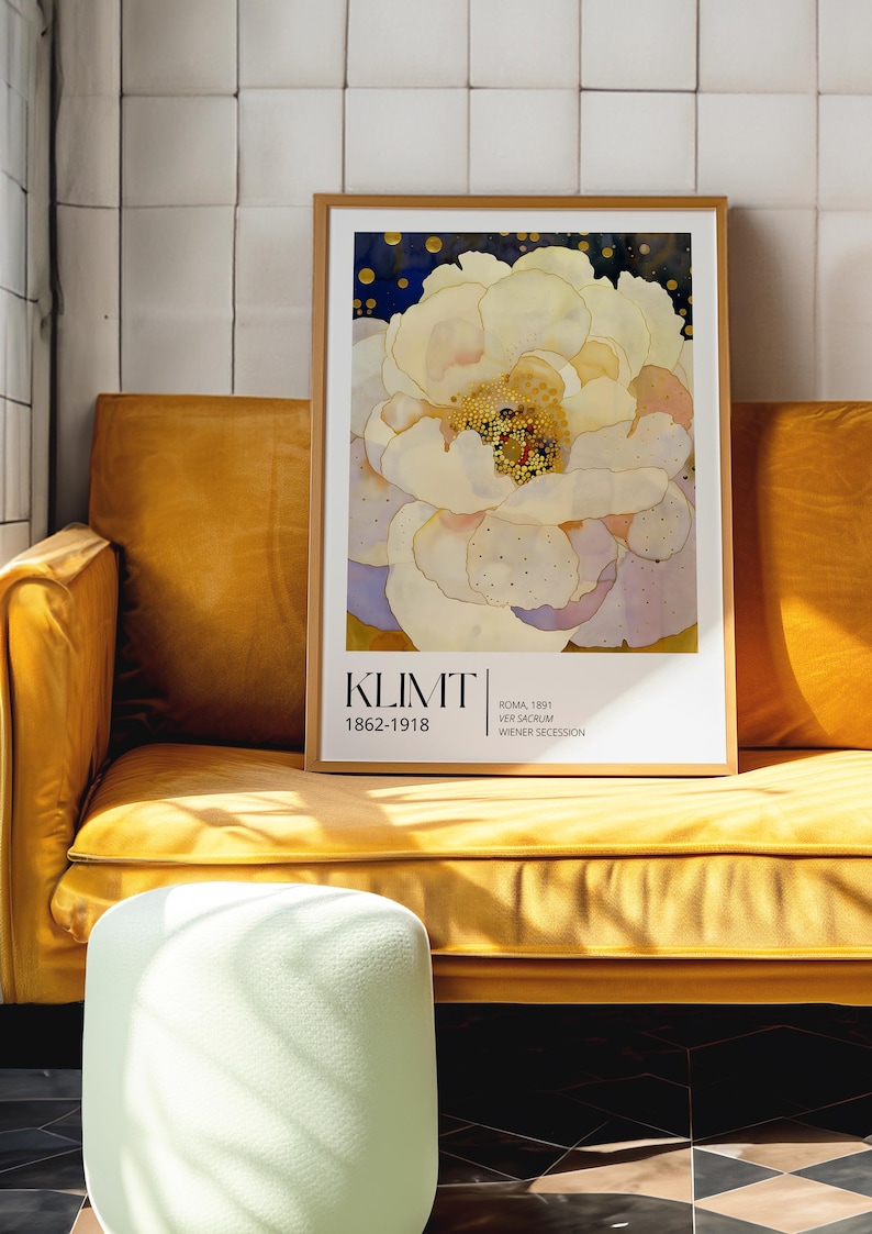 May include: A framed art print featuring a large, pale yellow and white flower with a dark blue background. The text KLIMT 1862-1918, ROMA, 1891, VER SACRUM, and WIENER SECESSION is printed in black at the bottom of the white border within the frame.