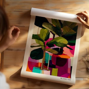 May include: A rectangular art print featuring a stylized green fiddle leaf fig plant in a light blue pot, set against a vibrant abstract background of pink, orange, and purple geometric shapes. The text PICASSO 1927 is printed in the bottom right corner.
