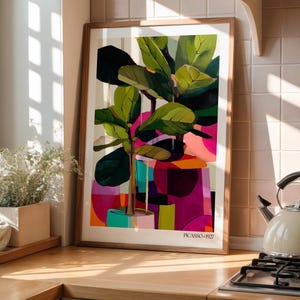 May include: A framed art print featuring a stylized fiddle leaf fig plant in a pot, rendered in vibrant shades of green, pink, purple, and orange. The composition includes abstract geometric shapes and the text PICASSO 1927 at the bottom center.