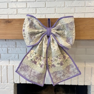 May include: A handmade wooden sign with the text "Welcome to our home" in a handwritten style. The sign is painted white with black lettering and a distressed finish, perfect for indoor or outdoor use.