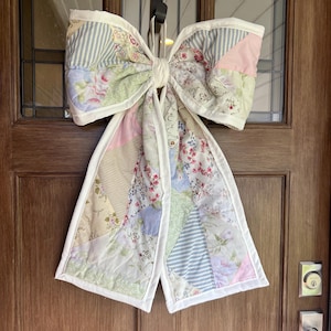 May include: A set of three ceramic mugs with a speckled, matte finish in cream, light grey, and dark grey. Each mug has a simple, minimalist design, suitable for coffee or tea.