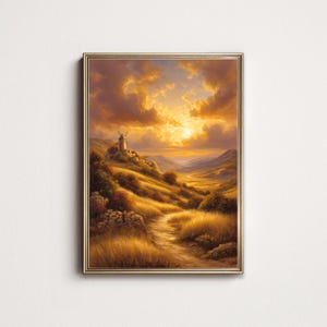 May include: A framed landscape painting depicts a golden sunset over rolling hills and a winding path. A windmill sits atop a hill, and the sky is filled with warm, orange and yellow clouds. The artwork is framed in a gold-colored frame.