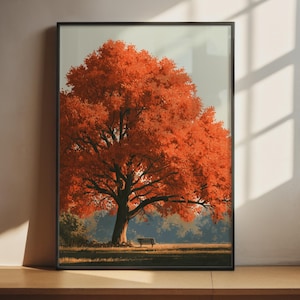 May include: A framed wall art print featuring a large tree with vibrant orange autumn leaves standing in a grassy field. A small bench is positioned beneath the tree canopy. The scene is set against a soft, light-coloured sky background.