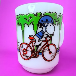Vintage 1958 Snoopy “Pedal Power” Mug by Fire-King / Anchor Hocking, White Milk Glass Peanuts Mug, Cycling Snoopy Coffee Cup 4” USA