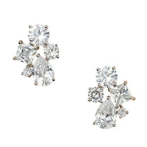 May include: A pair of sparkling stud earrings with a cluster design. Each earring features a mix of clear, round, square, and pear-shaped cubic zirconia stones set in a gold-tone metal. The earrings are displayed against a white background.