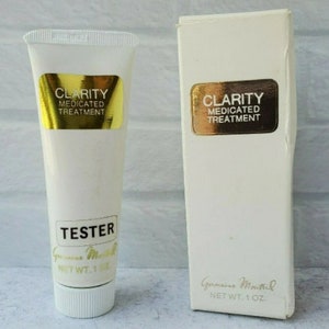May include: A white tube of Clarity Medicated Treatment, labeled "Tester" and "Genuine Mouthil" with a net weight of 1 oz. The tube is next to a white box with the same label.