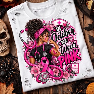 May include: A white distressed t-shirt featuring a graphic of a nurse with a stethoscope, pink flowers, and a breast cancer awareness ribbon. The text reads, In October We Wear Pink, accompanied by a nurse cap icon and a medical clipboard graphic.