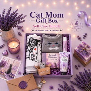 May include: A Cat Mom Gift Box self-care bundle containing a white towel with a cat graphic, gray cat-themed socks, a lavender soap bar, lavender hand cream, a lip balm, a small cat figurine in a box, and a cat keychain with a flower charm.
