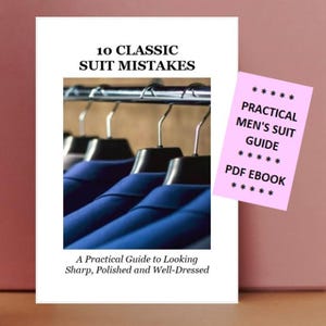 May include: A digital guide titled 10 CLASSIC SUIT MISTAKES featuring a photograph of blue suit jackets on hangers. A pink overlay includes the text PRACTICAL MEN'S SUIT GUIDE PDF EBOOK. The bottom text reads A Practical Guide to Looking Sharp.