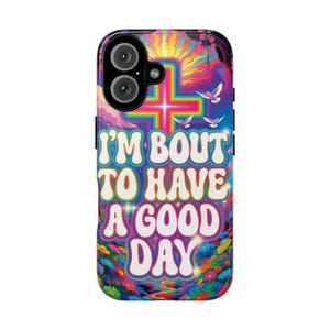 May include: A colorful phone case with a vibrant design. The case features the text "I'M BOUT TO HAVE A GOOD DAY" in white bubble letters. The background includes a cross, doves, and a rainbow-colored sky.