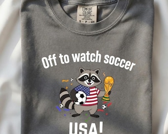 Comfort Colors Off To Watch Soccer Raccoon Shirt | Funny World Cup 2026 Gift | National Team Football Art | Retro Sports Raccoon T-Shirt
