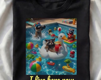 I Live Here Now Raccoon Shirt | Funny Summer Vacation Gift | Retro Pool Party Trash Panda Art | Trendy Beach Vibes Graphic Tee