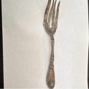 May include: A set of three ceramic mugs with a speckled, matte finish. The mugs are in shades of cream, light gray, and dark gray. Each mug has a simple, minimalist design and a rounded handle.