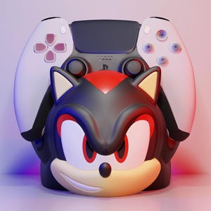 May include: A black, red, and tan Shadow the Hedgehog character design with a white and black games controller. The controller is positioned behind the character's head. The character has red eyes and a smiling expression.