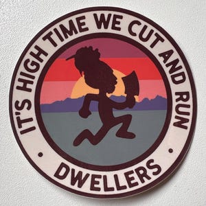 May include: Circular sticker with the text "IT'S HIGH TIME WE CUT AND RUN DWELLERS" in a white border. The center features a silhouetted figure running with a hatchet against a sunset backdrop of red, orange, and purple.