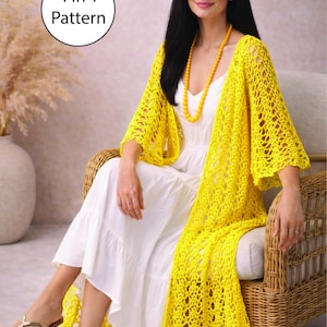 May include: A woman wearing a bright yellow, open-weave crochet shawl over a white dress. The shawl is long and drapes over the shoulders. The text "4 in 1 Pattern" is in a white circle. She is seated in a wicker chair.