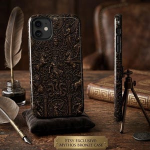 May include: A bronze-toned phone case featuring detailed relief carvings of mythological scenes. The case is shown on a small black cushion, with a side view highlighting the design. The text "ETSY EXCLUSIVE: MYTHOS BRONZE CASE" is displayed.