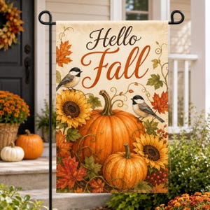 May include: A rectangular garden flag featuring the text Hello Fall in brown script. The design includes two black-capped chickadees, two large orange pumpkins, yellow sunflowers, and autumn leaves in shades of red, orange, and yellow.