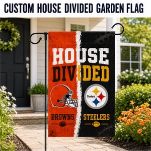 May include: A rectangular garden flag featuring a split design with an orange side for the Browns and a black side for the Steelers. The text reads HOUSE DIVIDED, BROWNS, and STEELERS. It includes a football helmet graphic and team logos.