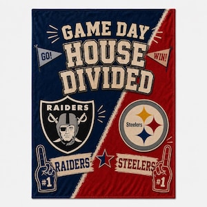 May include: A rectangular throw blanket featuring a split design with dark blue on the left and red on the right. The text reads GAME DAY HOUSE DIVIDED. It includes the Raiders logo and name on the blue side, and the Steelers logo and name on the red side, along with pennants and number one foam finger graphics.